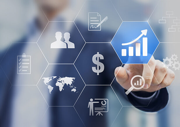 male using touchscreen with upward trending sales chart