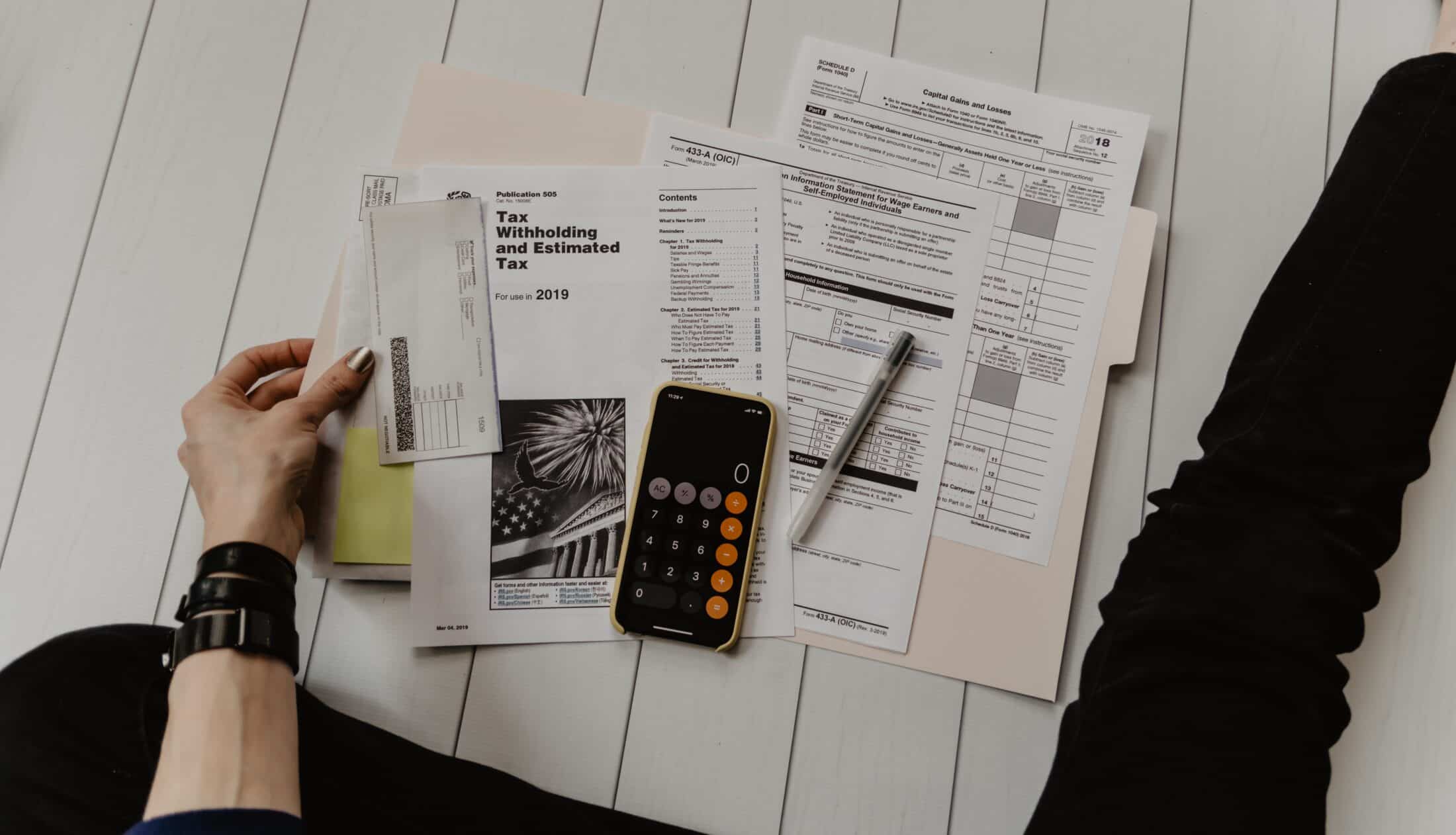 various tax forms and documents spread on wood floor